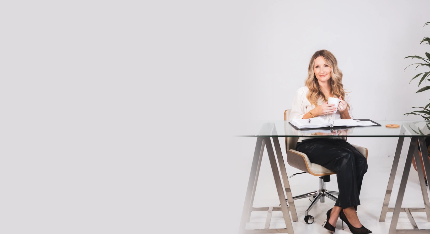 Attorney Lauren K. Fyfe seated at her glass desk